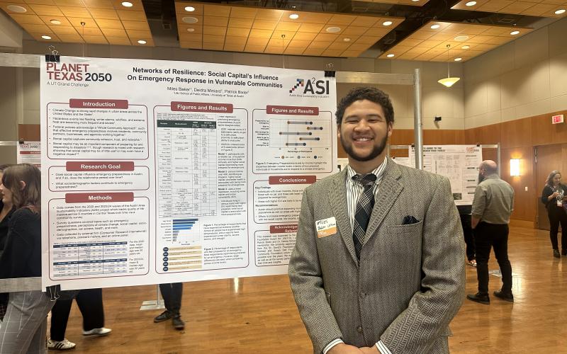 student presenting research poster